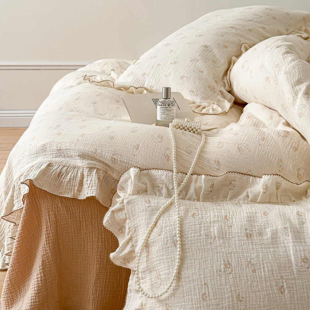 A full shot of the twin bed with the lamb print bedding set, styled with a solid-colored flat sheet