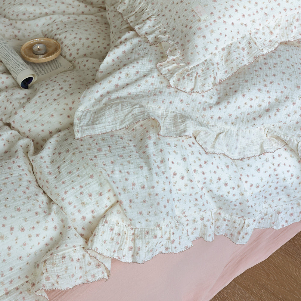 Close-up of soft ruffled pillowcase and duvet cover with tiny floral print