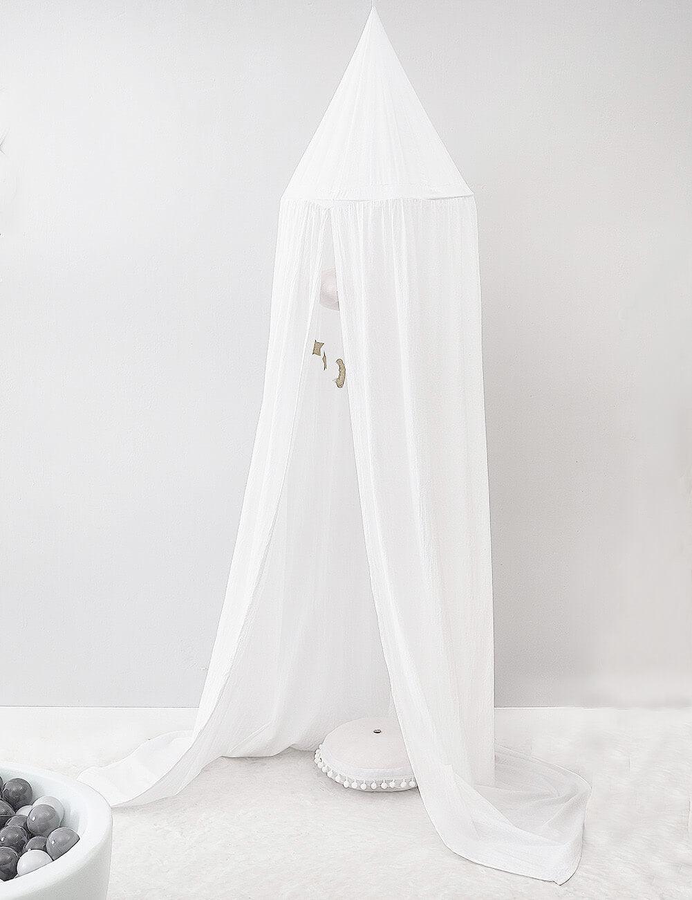 White long bed canopy set up as a cozy reading tent in a child's room.
