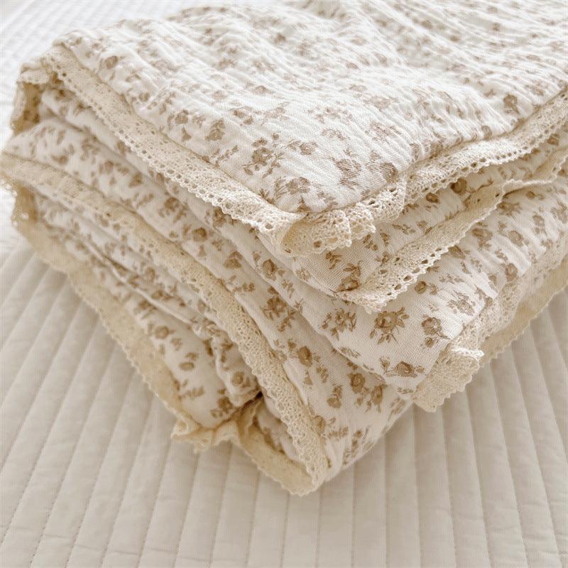 Detailed texture of floral cotton gauze crib quilt