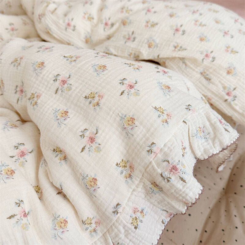 Close-up of pastel azalea flowers and ruffled edge on muslin duvet cover
