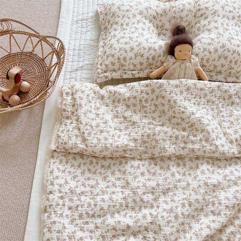 Folded view of quilted camellia baby blanket