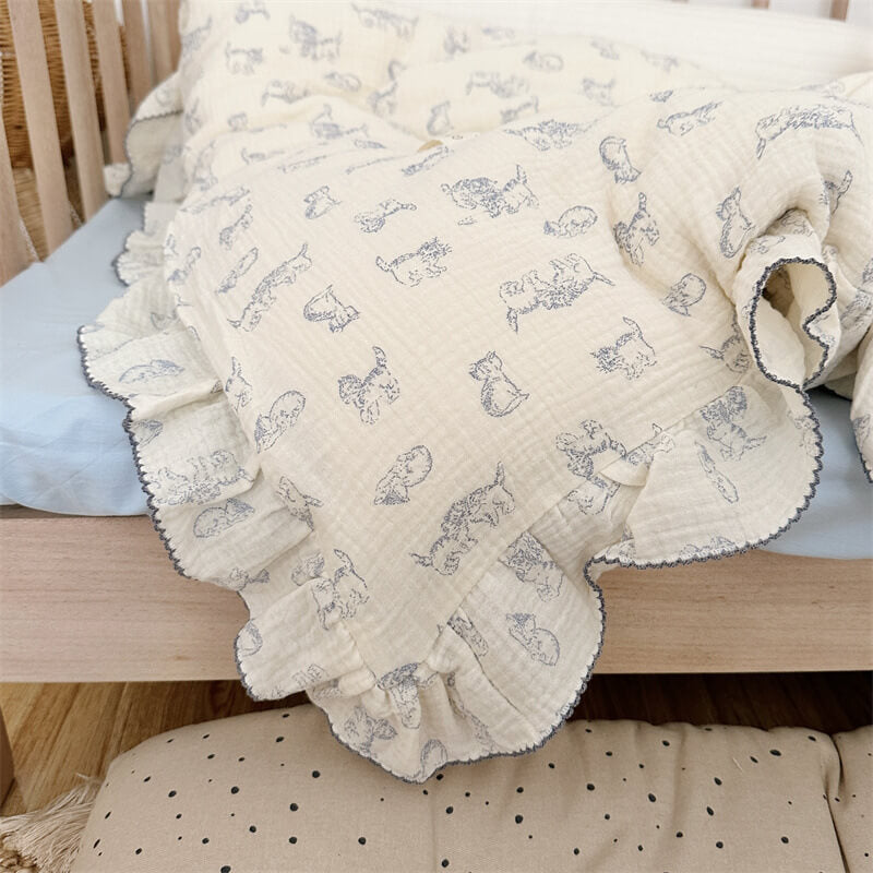 Close-up of blue kitty print on ruffled cotton muslin bedding