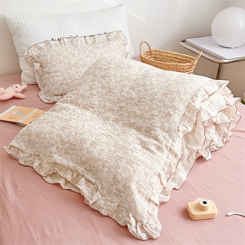 Woodland duvet cover set with ruffled trim styled on bed with bunny plush and white pillow