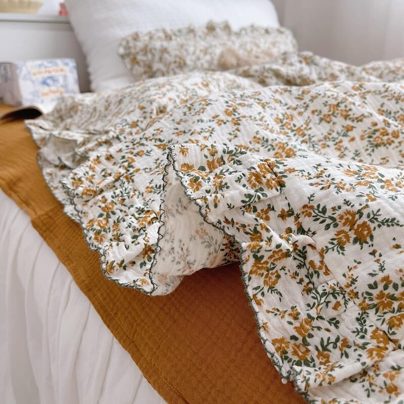 Hibiscus floral ruffle bedding set styled with caramel fitted sheet