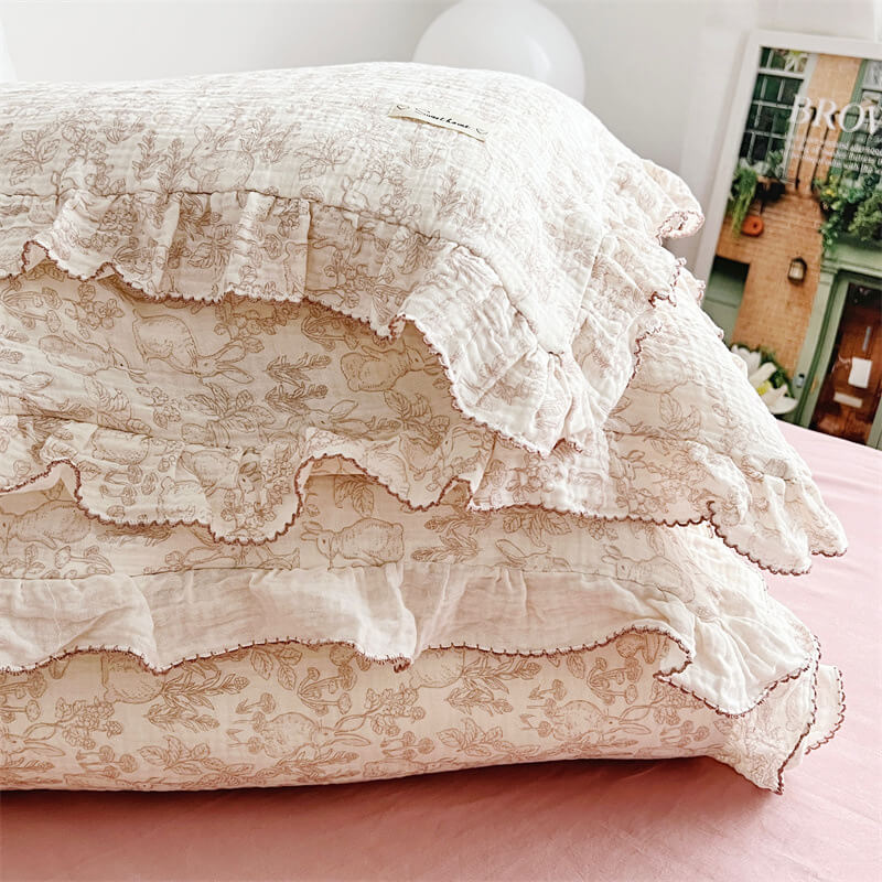 Folded woodland ruffled duvet cover and pillowcase set on pink bedding