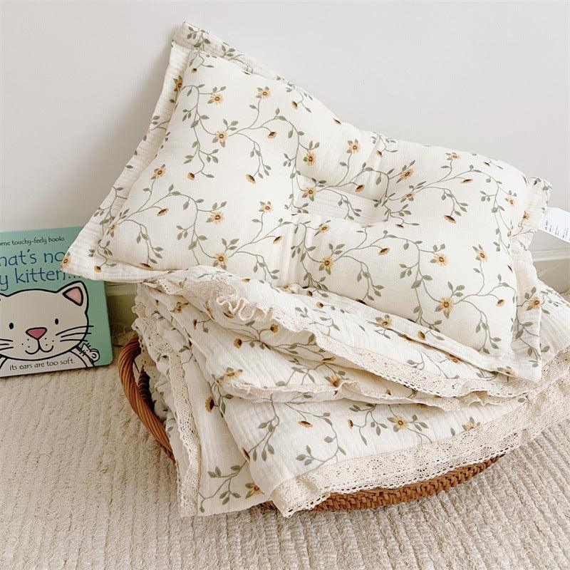 Lightweight cotton muslin baby comforter folded to show floral details