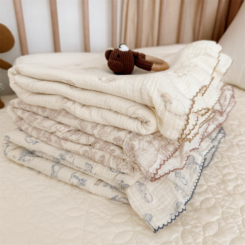 Cotton muslin ruffle duvet cover set with woodland animal print and brown trim, folded on bed