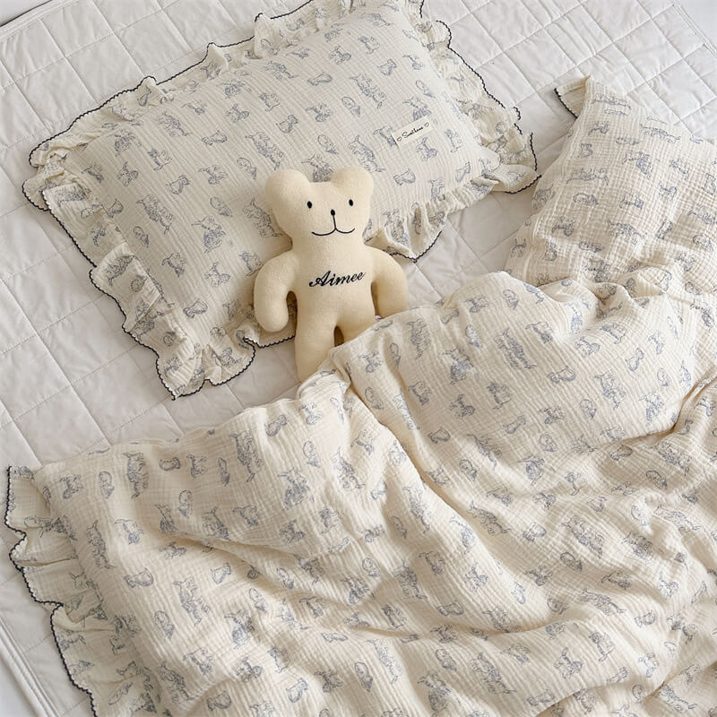 Ruffled kitty duvet cover set and pillowcase styled with plush bear doll