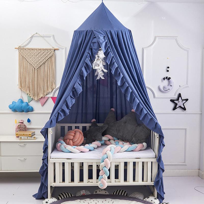 Blue ruffled bed canopy for a children's crib, perfect for a nursery.