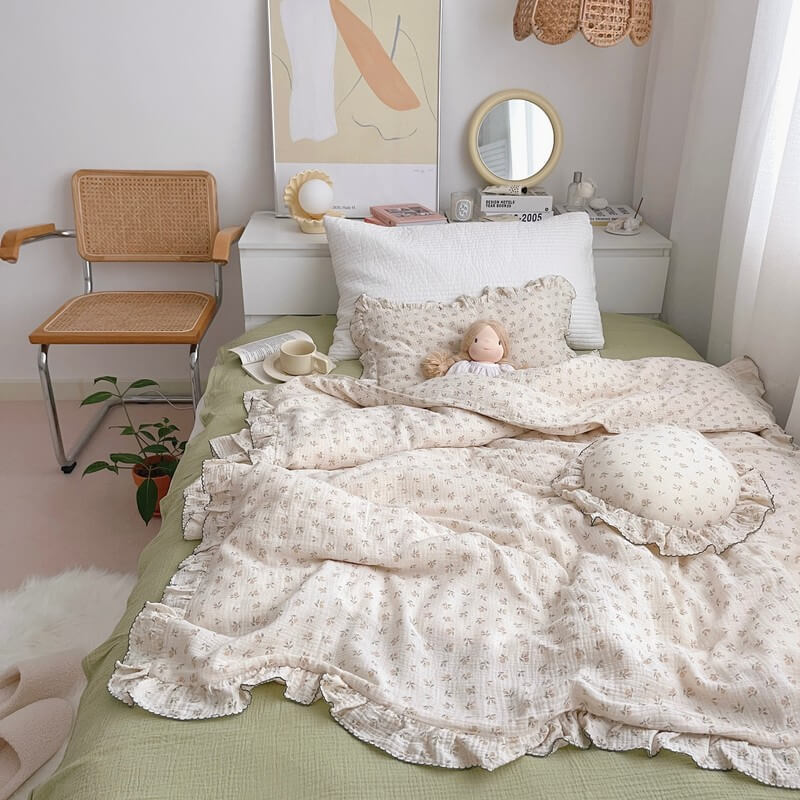 Vintage ruffle duvet cover set in floral cotton muslin, styled in a cozy bedroom
