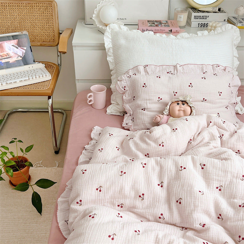 Ruffled cotton muslin duvet cover set with cherry print, styled on bed