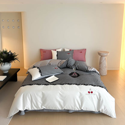 Bedroom with checkered bedding and decorative pillows