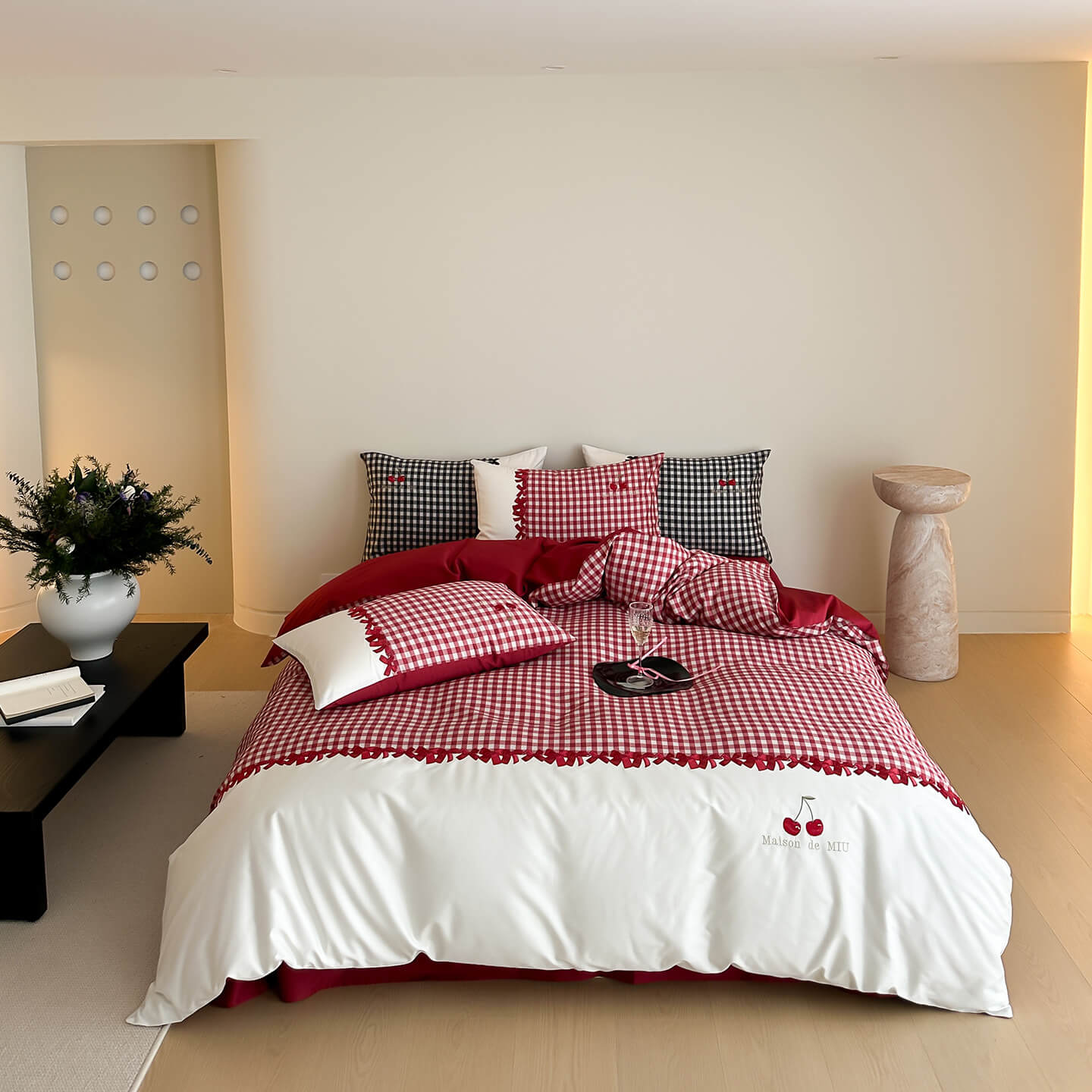 Bed with red and white checkered bedding in a modern bedroom setting.
