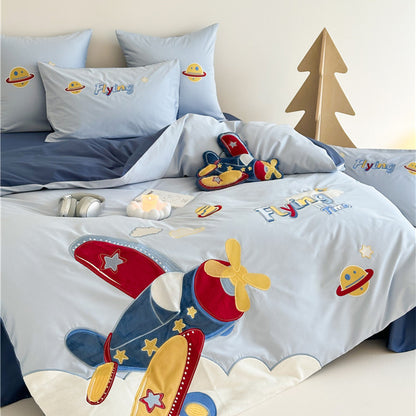 Children's bedroom with space-themed bedding featuring rockets and planets.