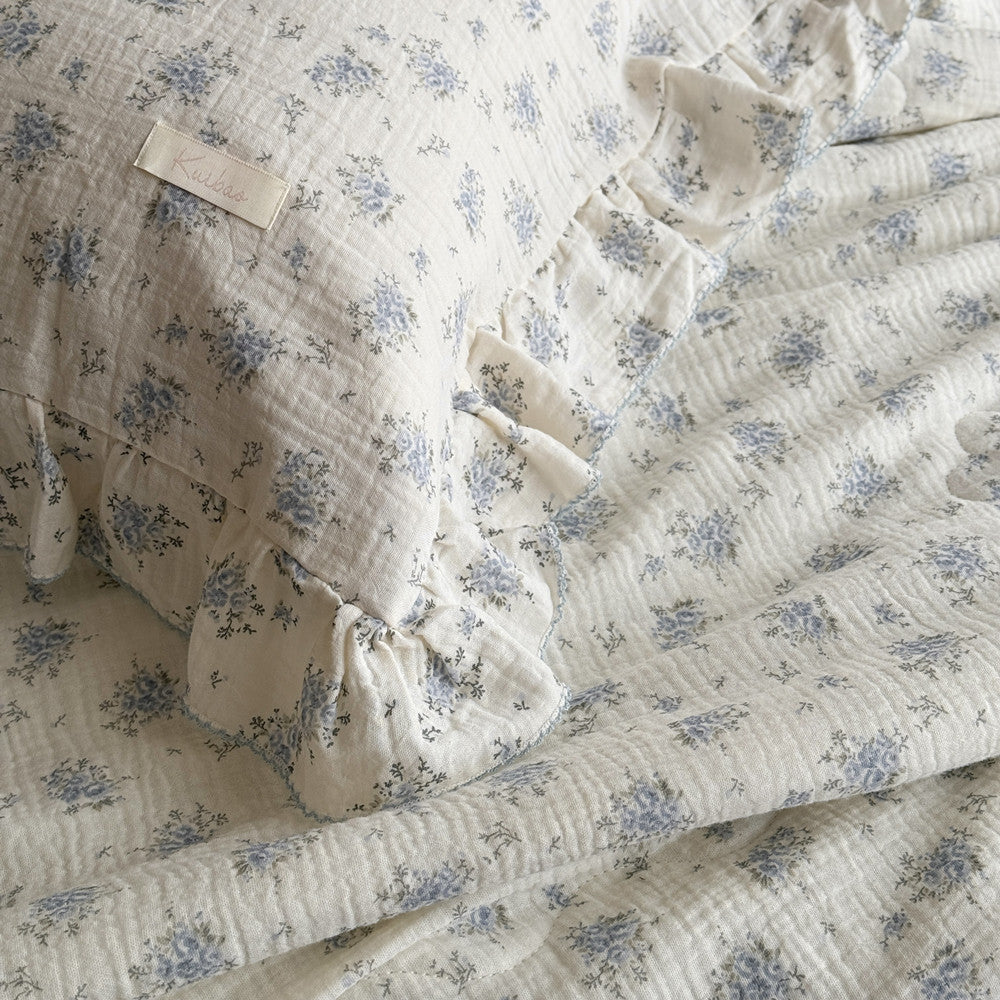 Side view of pillow and comforter showing floral pattern and double ruffles