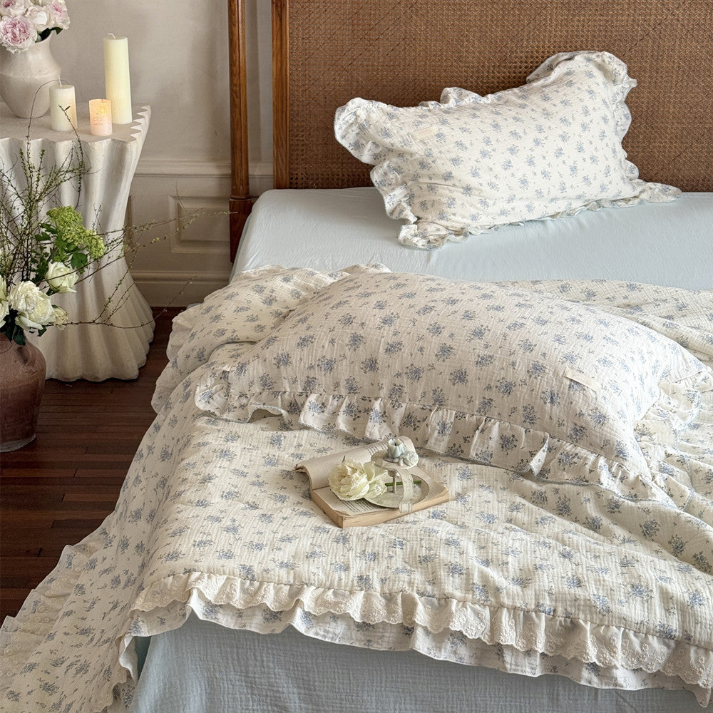 Decorated bedroom setting with floral bedding and pastel accents