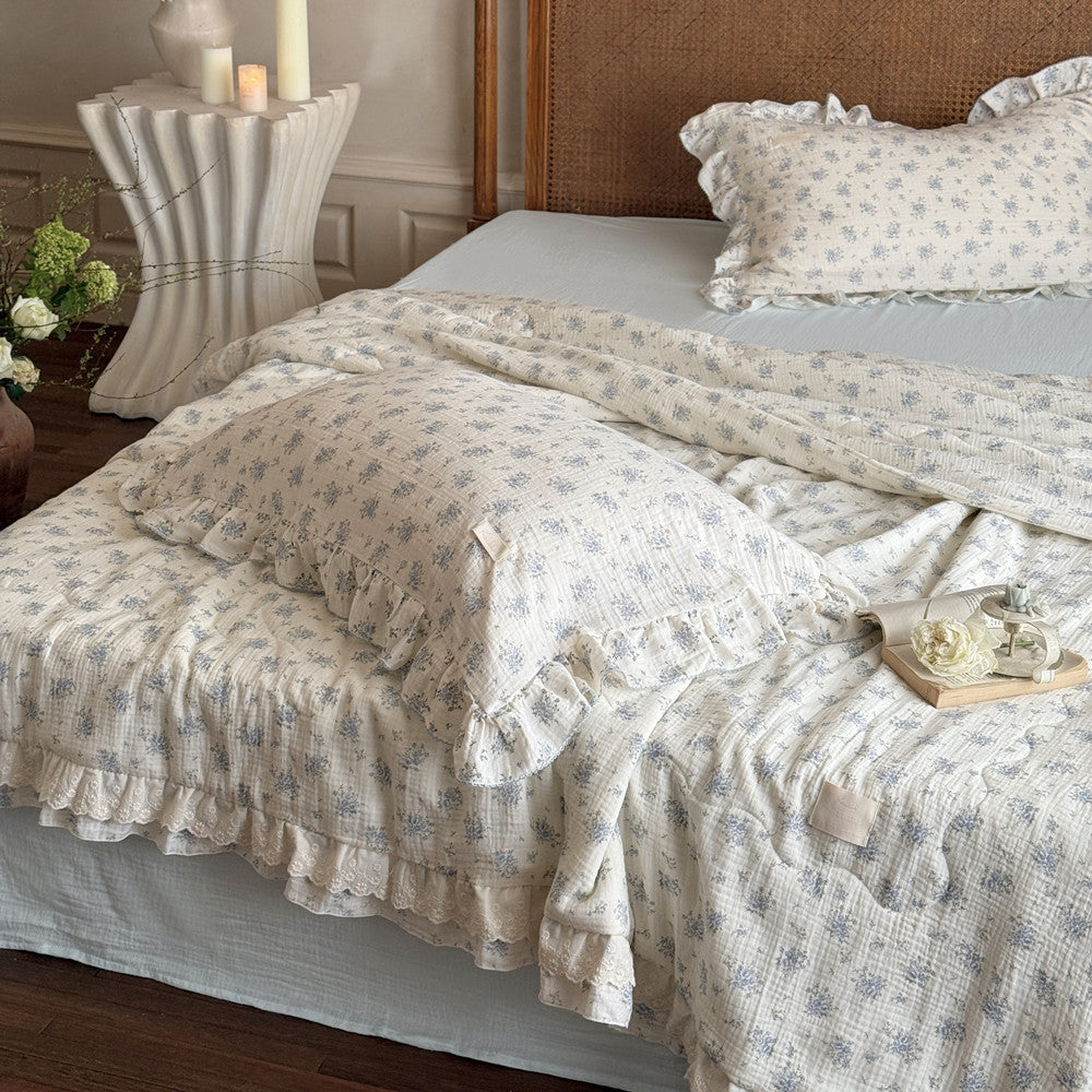 Neatly arranged pillows and comforter in soft floral cotton gauze