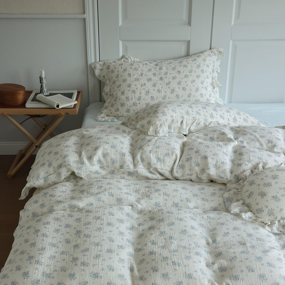 Blue floral duvet cover set styled with matching pillowcases and pale blue sheet for a teen bedroom