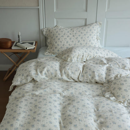 Blue floral duvet cover set styled with matching pillowcases and pale blue sheet for a teen bedroom