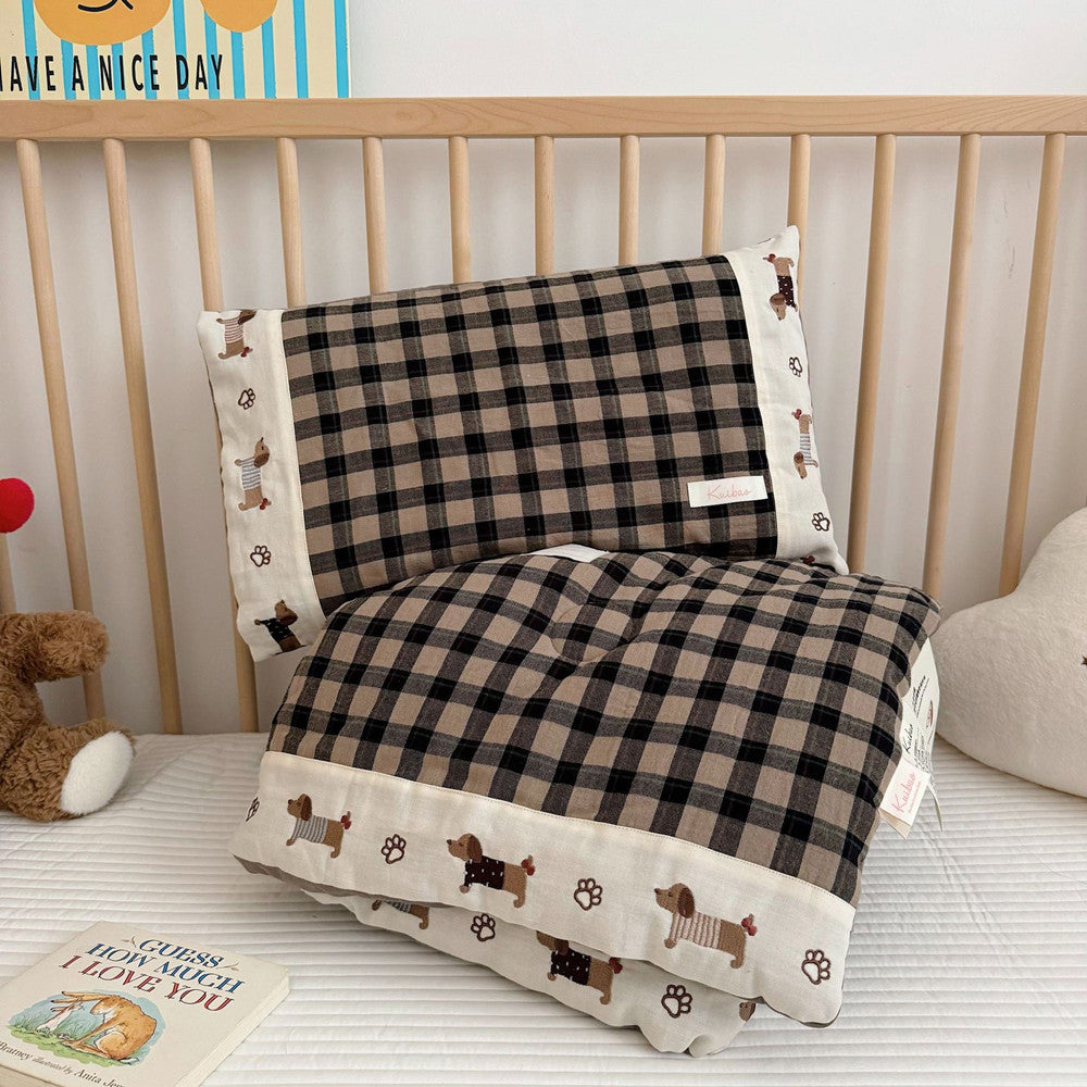 Children's bed with checkered bedding and teddy bear, featuring a 'Have a Nice Day' sign.
