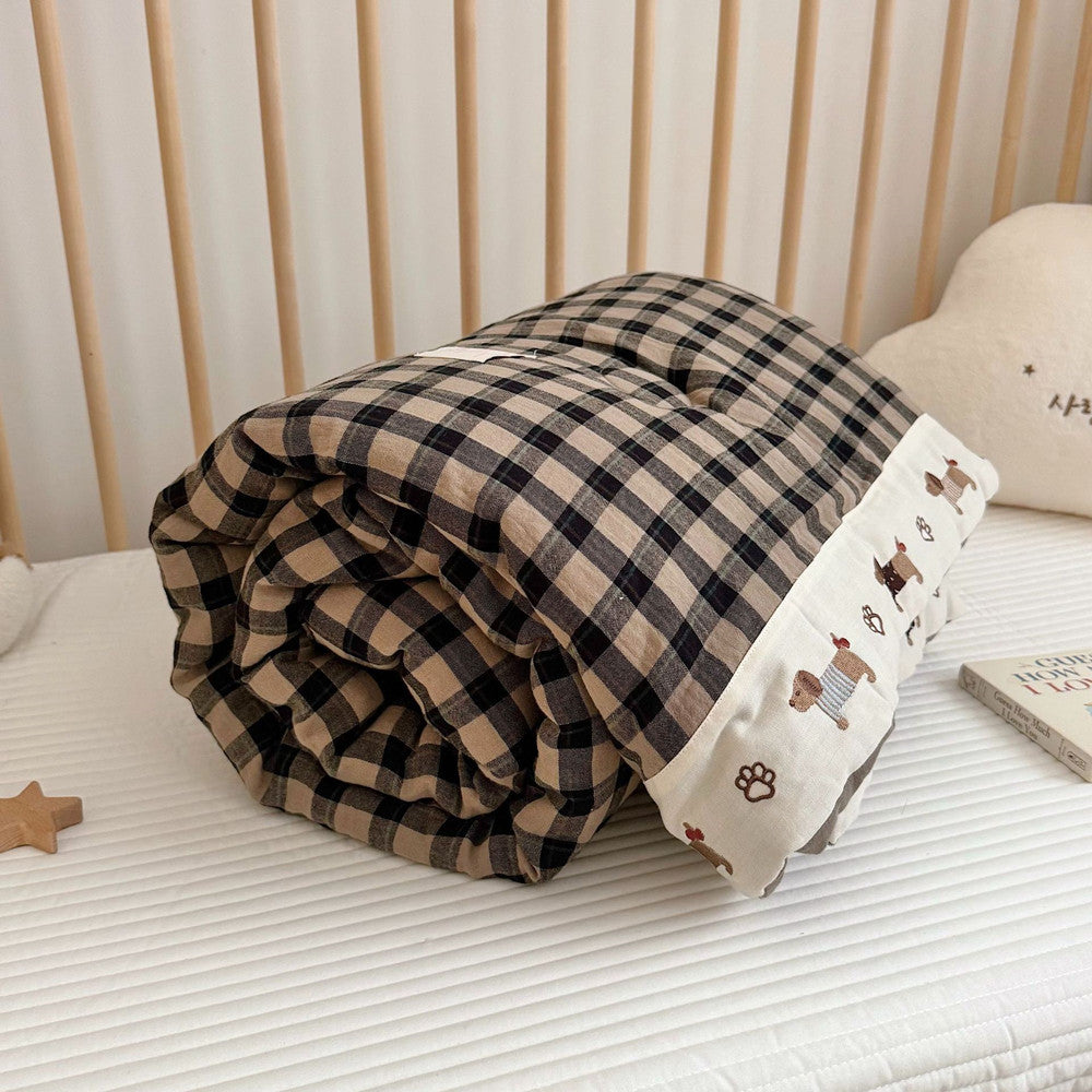 Plaid blanket with cartoon bear pattern on a bed