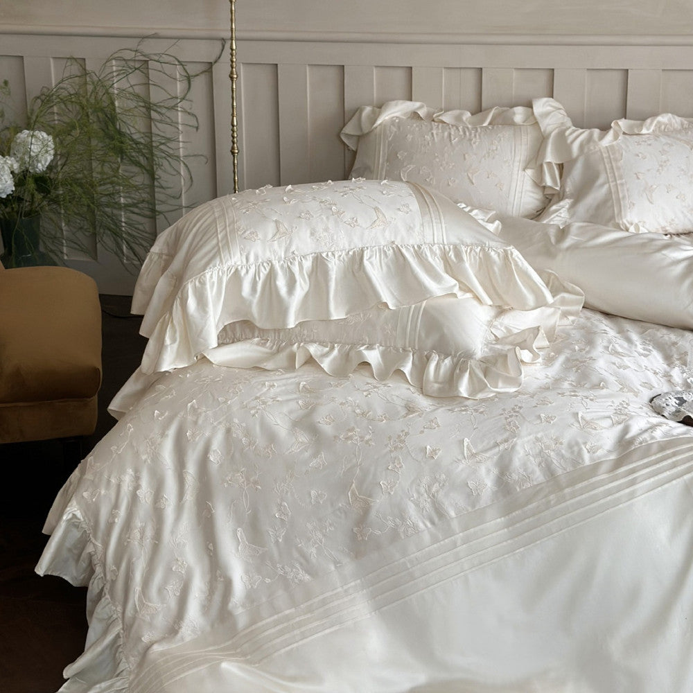 Close-up of ivory Butterfly Embroidered Bedding Set pillows, showing ruffles and 3D embroidery.