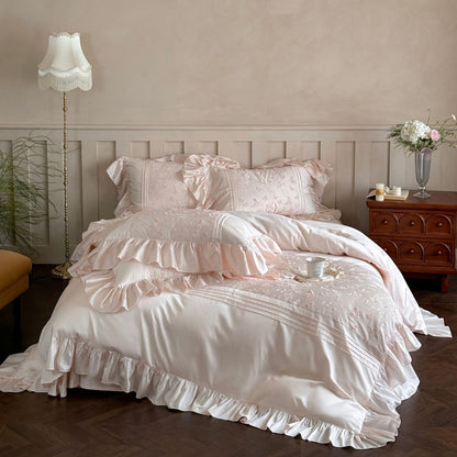 Full view of the pink Butterfly Embroidered Bedding Set with large ruffles and Tencel sheen.