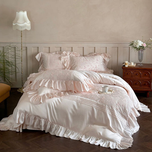 Full view of the pink Butterfly Embroidered Bedding Set with large ruffles and Tencel sheen.