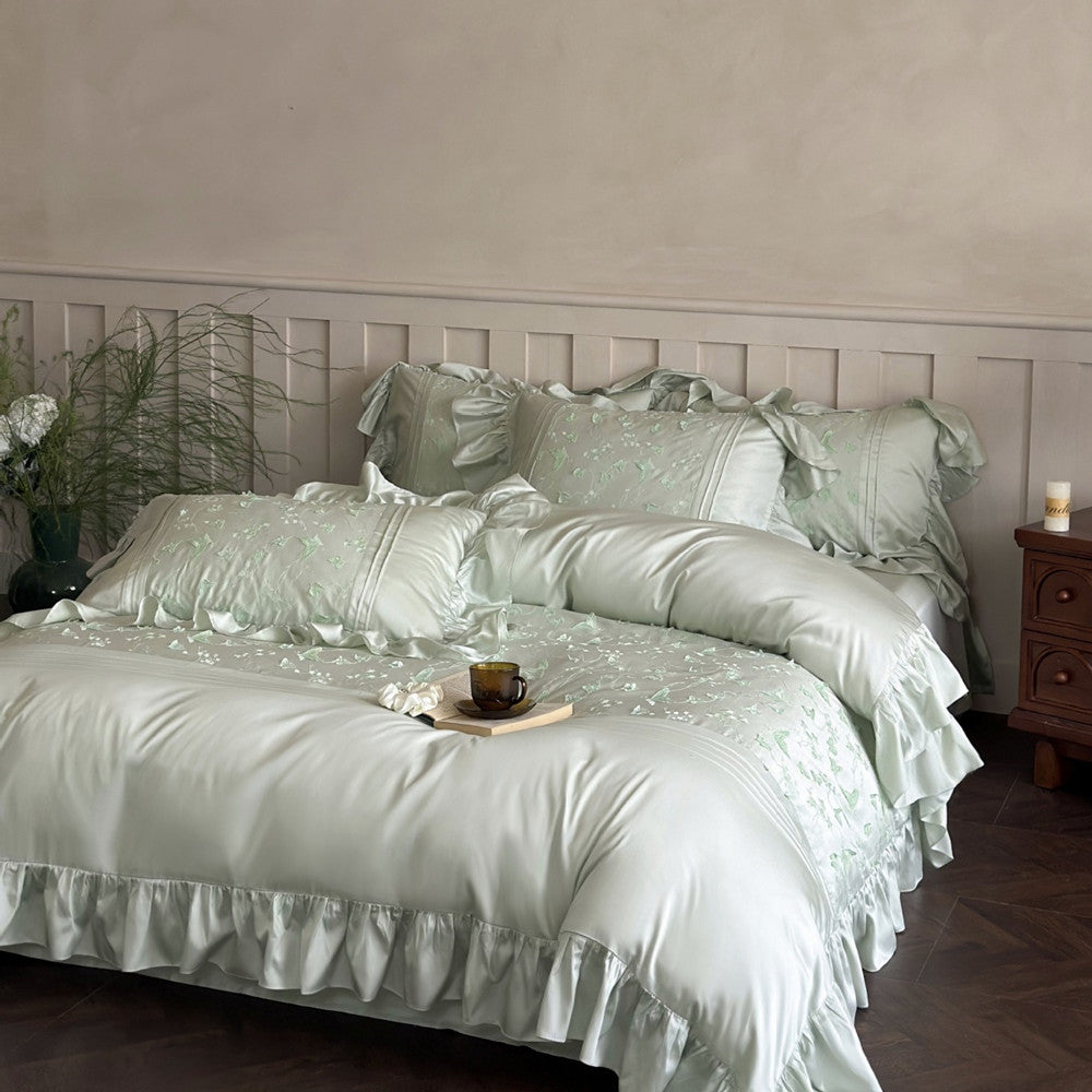 Styled image of the pale green Butterfly Embroidered Bedding Set showing a soft, silky finish.
