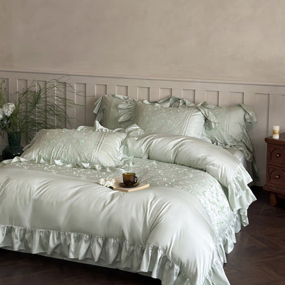 Styled image of the pale green Butterfly Embroidered Bedding Set showing a soft, silky finish.