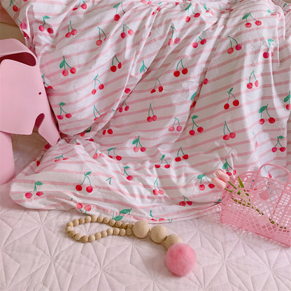 Pink and white striped fabric with cherry pattern on a textured surface