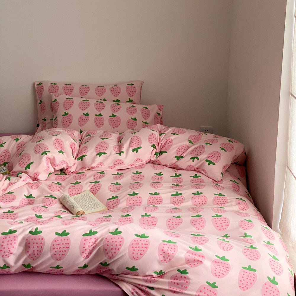Full pink strawberry bedding set styled on bed with soft cotton jersey fabric