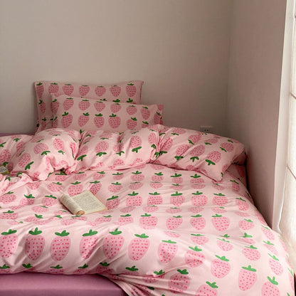 Full pink strawberry bedding set styled on bed with soft cotton jersey fabric