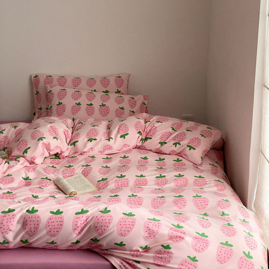 Full pink strawberry bedding set styled on bed with soft cotton jersey fabric