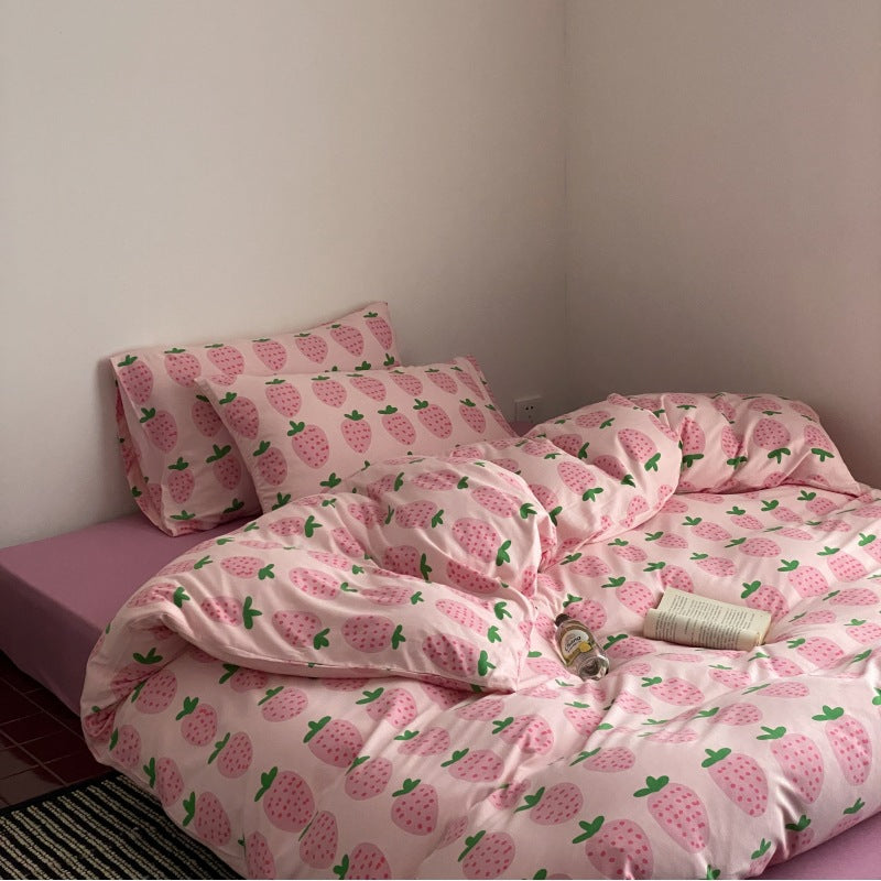 Cute pink strawberry bedding set styled in a simple teen bedroom