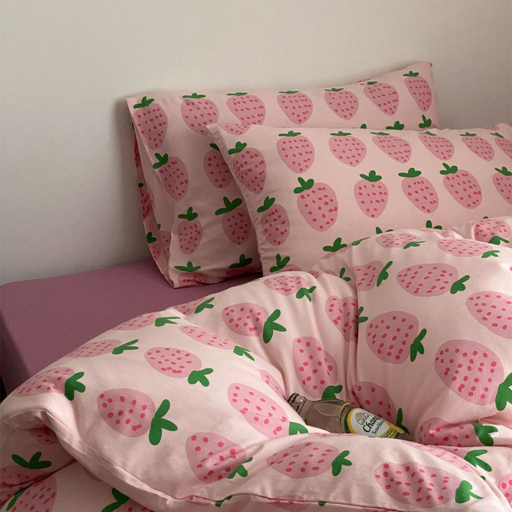 Close view of pink strawberry cotton jersey bedding with matching pillowcases