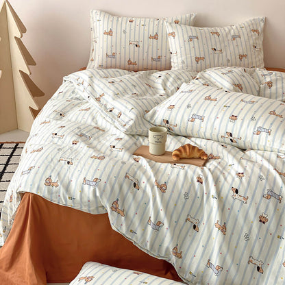 Cotton muslin kids bedding set with dachshund dog illustrations, pale blue stripes, rust flat sheet, and matching pillowcases
