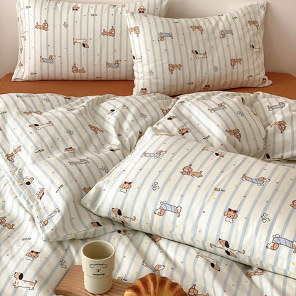 Close-up of dachshund stripe kids bedding set with matching pillowcases, blue striped duvet cover, and rust sheet