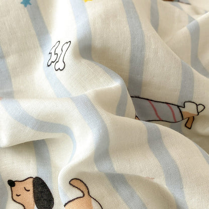 Soft cotton muslin fabric close-up with pale blue stripes, dachshund dog print, star accents, and visible woven texture