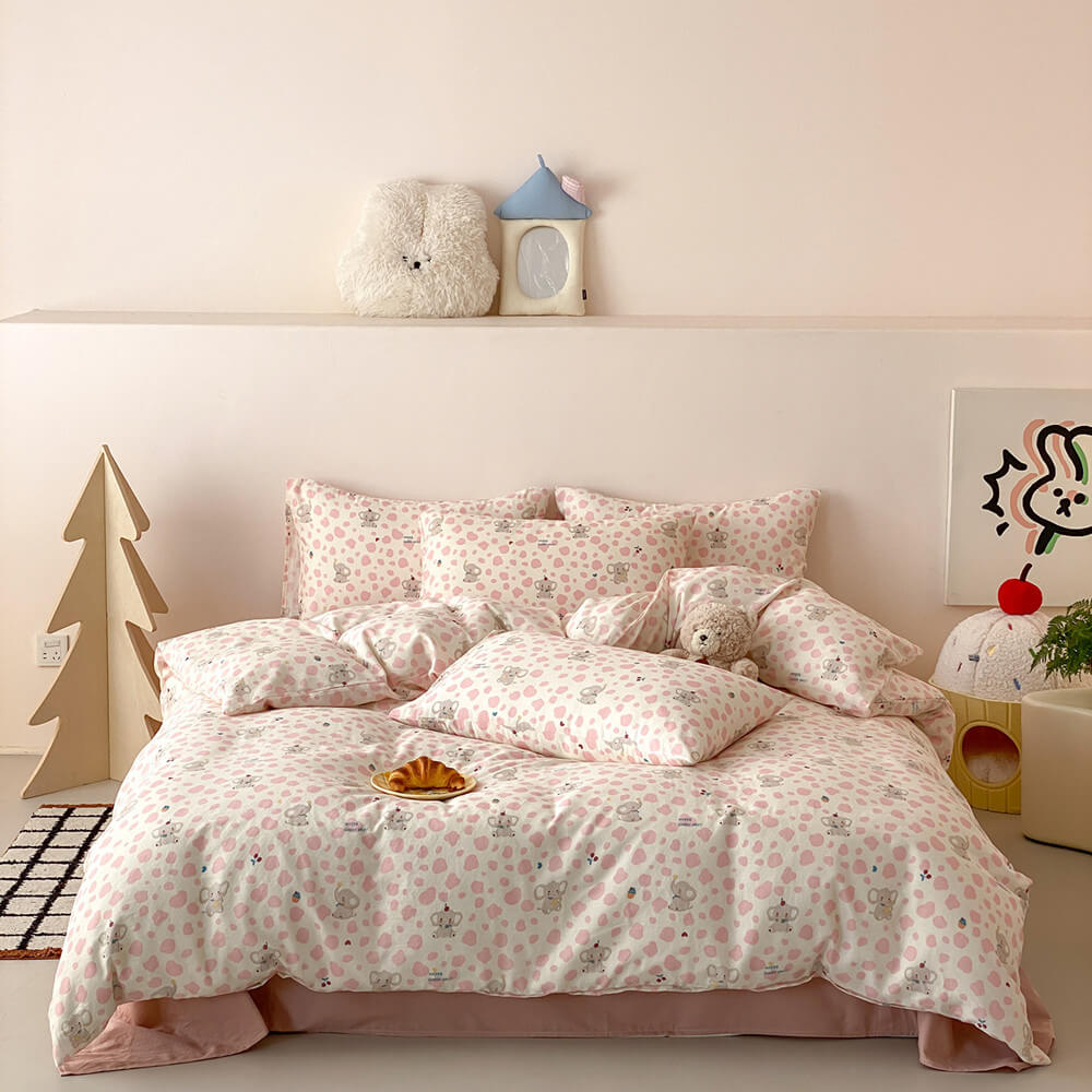 Pink elephant kids bedding set in cotton muslin with blush sheet, matching pillowcases, and sweet kids room styling