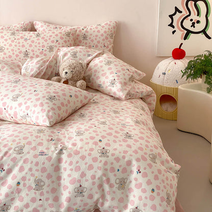 Pastel pink elephant kids bedding set with plush bear decor, cream base, pink spots, and matching pillowcases