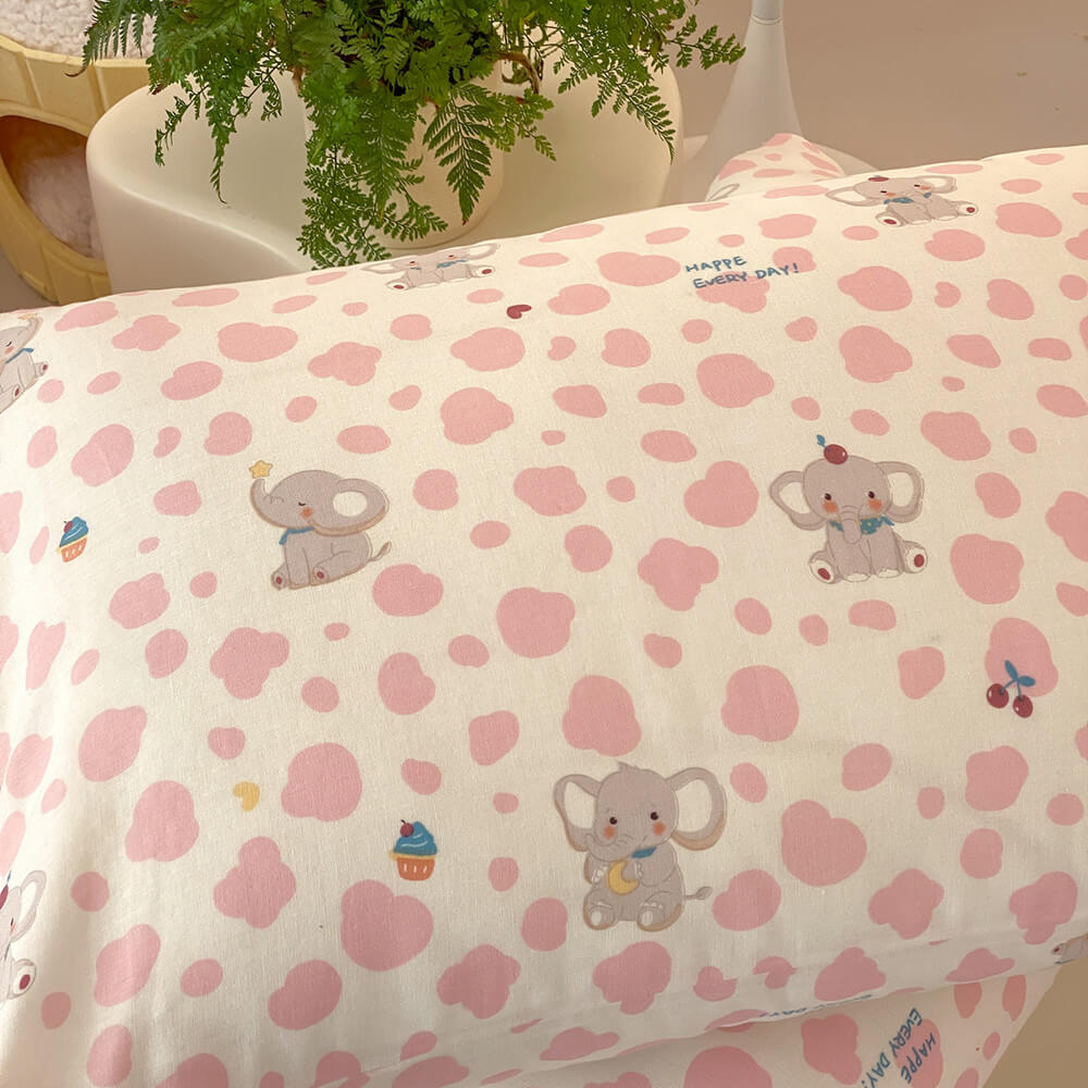Pink elephant cotton muslin pillowcase with cream base, pink spots, gray elephant motifs, and playful kids pattern details