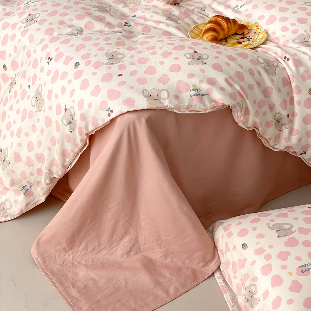 Pink elephant bedding set with blush flat sheet, cotton muslin duvet cover, and matching pillowcase detail