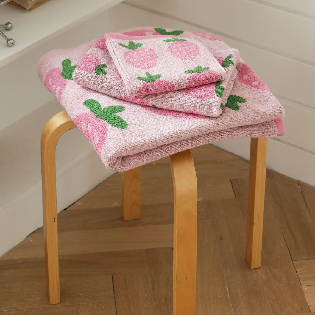 Folded pink strawberry towel set showing soft cotton terry fabric