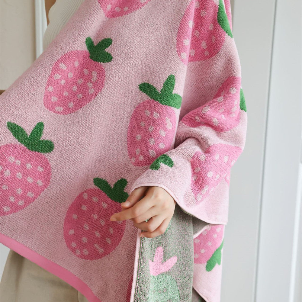 Pink strawberry bath towel showing cotton terry texture and green leaf pattern