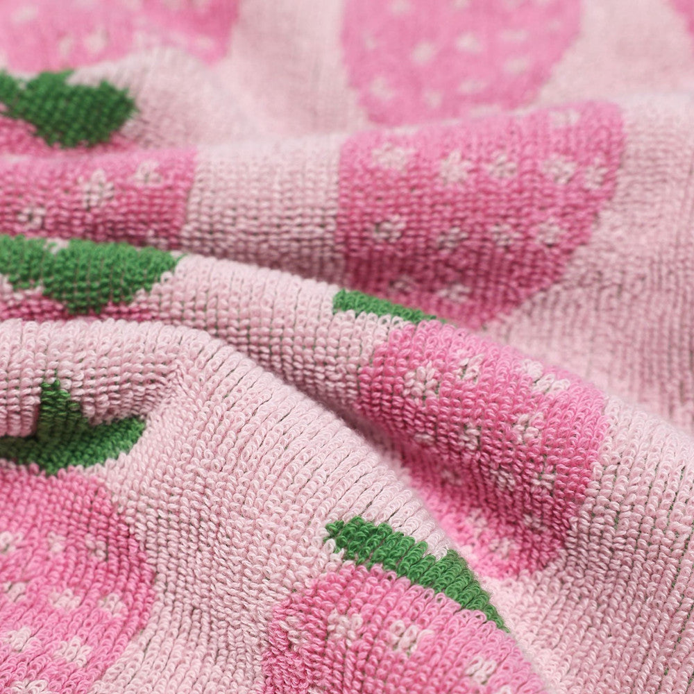 Close-up of soft terry cotton texture on pink strawberry towel