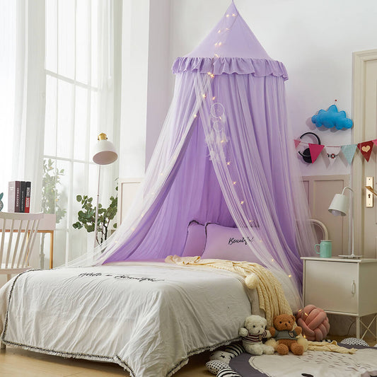 Wide view of a purple double-layer kids bed canopy over a white bed, styled as nursery room decor with a floor mat