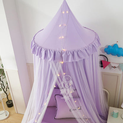 Close-up of a purple double-layer kids bed canopy, showing the ruffled top and sheer mesh with star lights for a whimsical decor.
