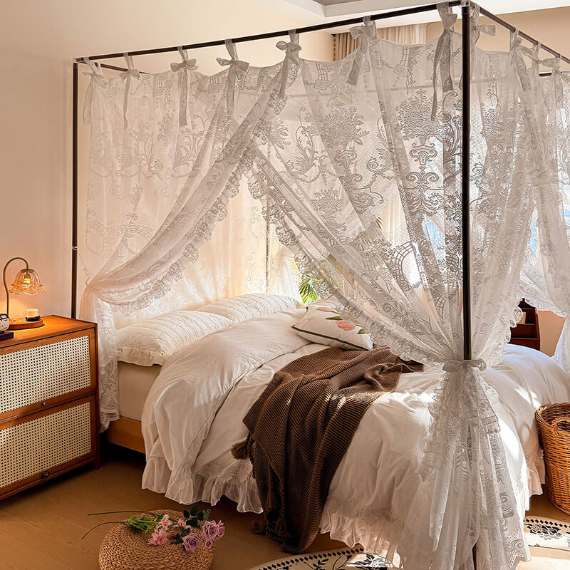 Bedroom with a canopy bed featuring lace curtains and a wooden nightstand.